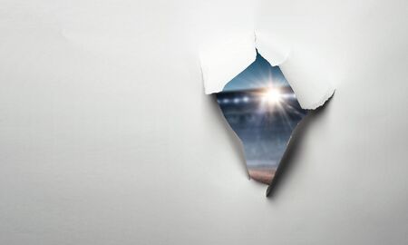 Paper torn hole effect with stadium viewの写真素材