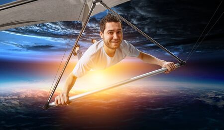 Young man flying on hang glider. Mixed mediaの写真素材