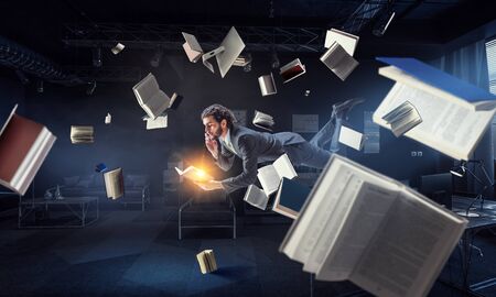 Joyful happe businessman levitating horizontallyの写真素材