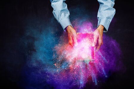 Man`s hands holding a small magic paper box, mixed media