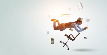 Smiling joyful levitating young man. Mixed mediaの写真素材