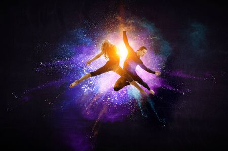 Young modern ballet dancers in a jump. Mixed mediaの写真素材