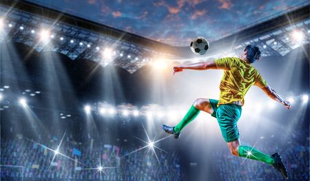 Soccer player on stadium in action. Mixed mediaの写真素材