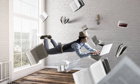 Smiling joyful levitating young man. Mixed mediaの写真素材