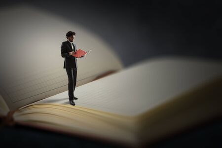 Young man reading a book. Mixed mediaの写真素材