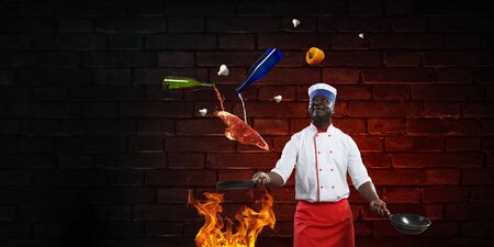 Black chef creative cooking. Mixed media.の写真素材