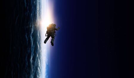 Astronaut at spacewalk on planet orbit.