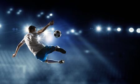 Soccer player on stadium in action. Mixed mediaの写真素材