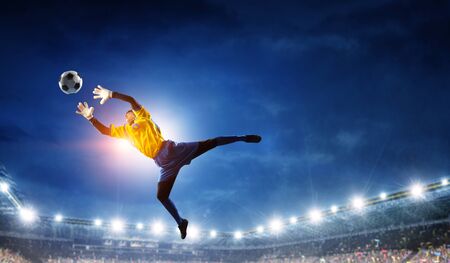 Soccer player on stadium in action. Mixed mediaの写真素材