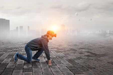 Young man in virtual reality. Mixed mediaの写真素材