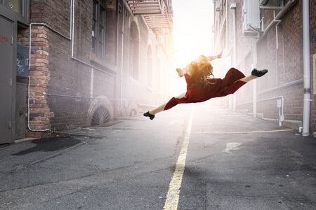 Young and beautiful female dancer in a red dressの写真素材