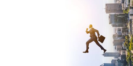 Running black businessman with briefcaseの写真素材