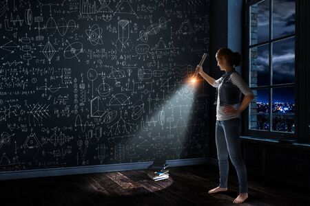 Young woman holding a flashlightの写真素材