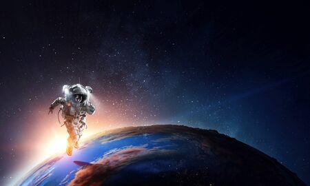 Spaceman and planet, human in space conceptの写真素材