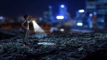 Young woman holding a flashlightの写真素材