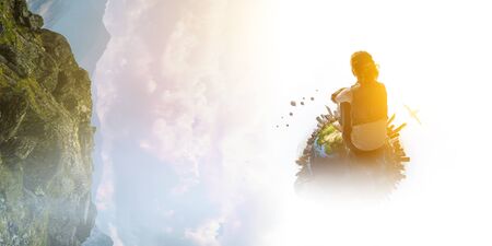 Young woman in casual clothes sitting and hugging kneesの写真素材