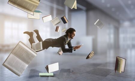 Joyful happe businessman levitating horizontallyの写真素材