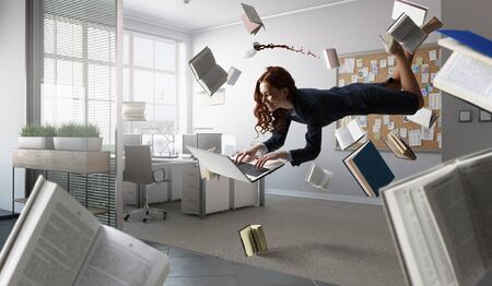 Joyful beautiful young levitating businesswomanの写真素材