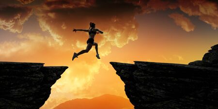 Jumping over precipice, challenge concept.の写真素材