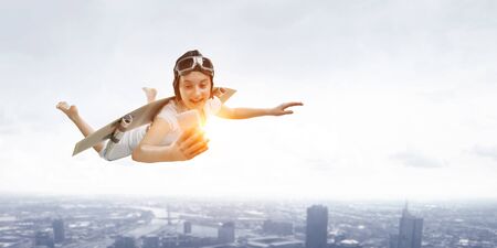 A woman fly with self-made plane wingの写真素材