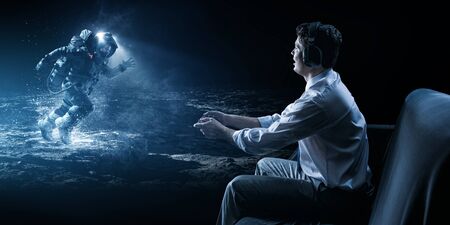 Young man playing space adventure video game