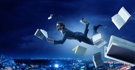 Joyful happe businessman levitating horizontallyの写真素材
