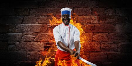 Black chef creative cooking. Mixed media.の写真素材