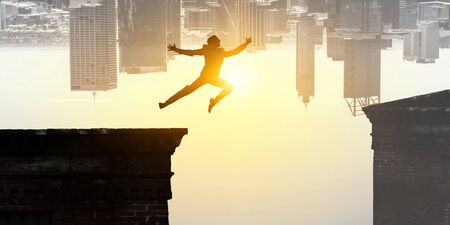 Jumping over precipice, challenge concept.の写真素材