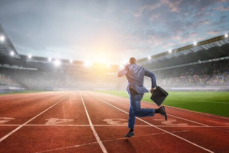 Running black businessman with briefcaseの写真素材