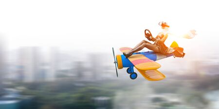 Woman in retro airplane . Mixed mediaの写真素材