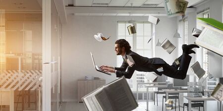 Joyful happe businessman levitating horizontallyの写真素材