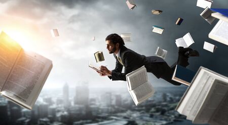 Man flies and works on laptop. Mixed mediaの写真素材