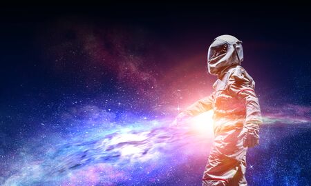 Astronaut in a space-suit on dark starry space backgroundの写真素材