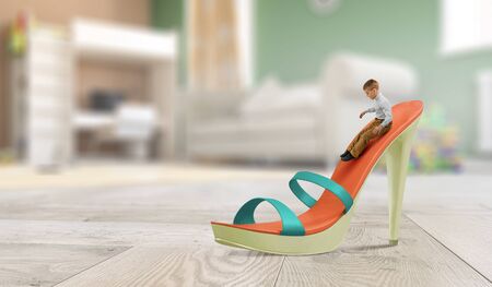 Happy boy having game on big shoe. Mixed mediaの写真素材