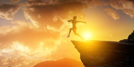 Jumping over precipice, challenge concept.の写真素材