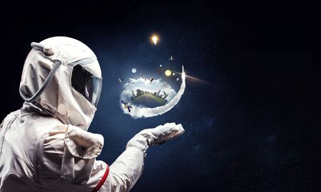Astronaut man wearing suit in space. Mixed media
