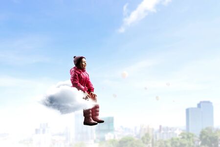 Child float on cloud . Mixed mediaの写真素材