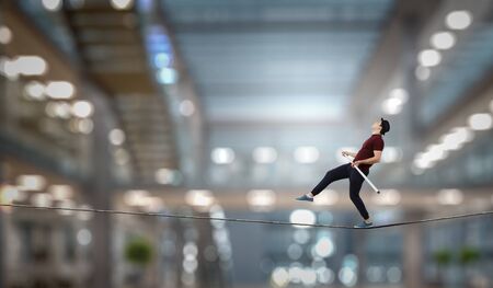 Brave ropewalker on cable. Mixed mediaの写真素材