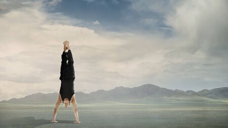 Amazing yoga man doing one handstand outdoor. Mixed media