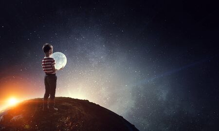 Boy holds the moon . Mixed mediaの写真素材