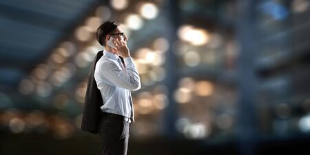 Businessman having mobile talk . Mixed mediaの写真素材