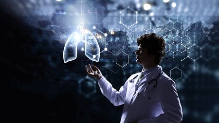 Young man doctor using new media technologies. 3d renderingの写真素材