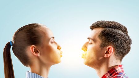 Guys kissing girl on blue background.の写真素材