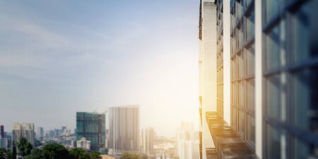 Modern business city building and rays of sunrise