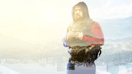 Hiker man in mountains. Mixed mediaの写真素材