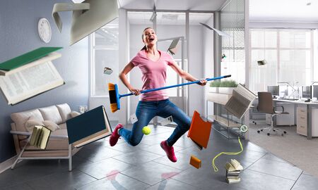 Woman doing funny cleaning. Mixed mediaの写真素材