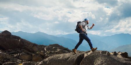 Male tourist with backpack walking outdoor. Mixed mediaの写真素材