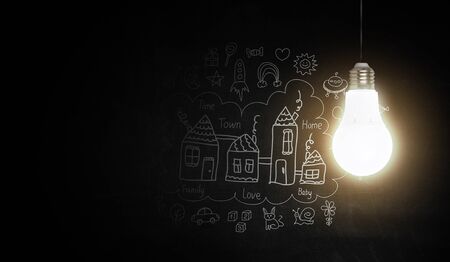 Glass glowing light bulb on dark backgroundの写真素材