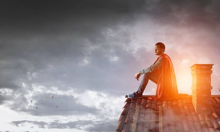Super hero on roof. Mixed mediaの写真素材