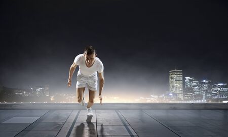 Athlete man running race. Mixed mediaの写真素材